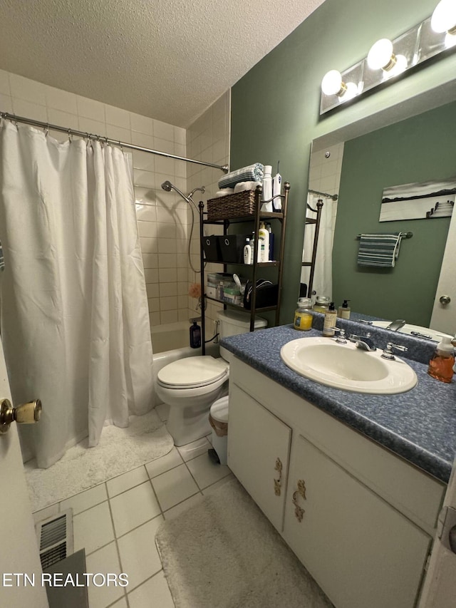 full bathroom featuring shower / bath combo, a textured ceiling, vanity, tile patterned flooring, and toilet