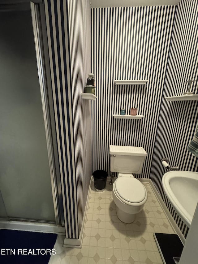 bathroom featuring toilet and walk in shower