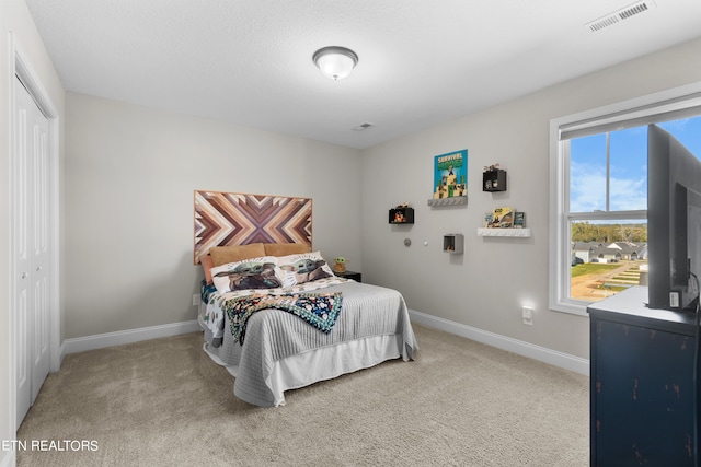 carpeted bedroom featuring a closet