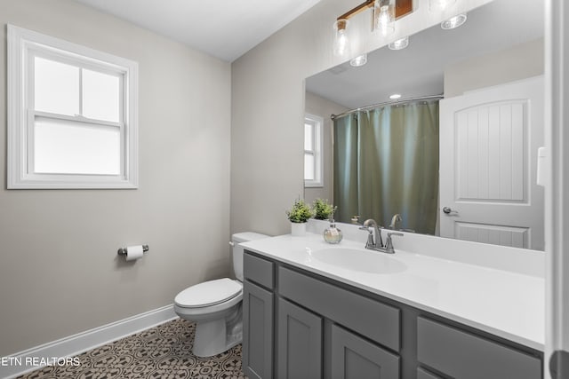 bathroom featuring vanity, toilet, and tile patterned floors