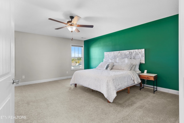 bedroom featuring ceiling fan and light carpet