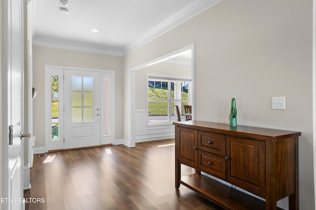 foyer entrance with crown molding and dark hardwood / wood-style flooring