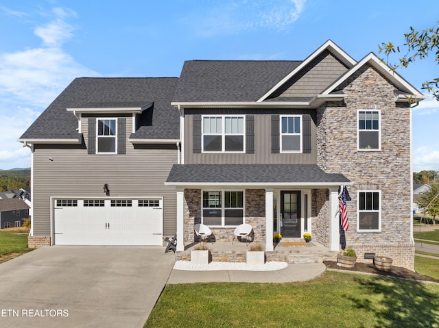 craftsman inspired home featuring a porch, a front lawn, and a garage