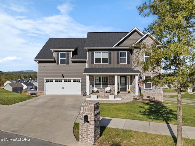 craftsman inspired home with a garage and a front lawn