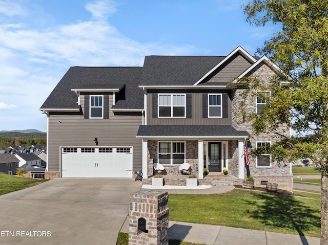 craftsman-style home featuring a front yard and a garage