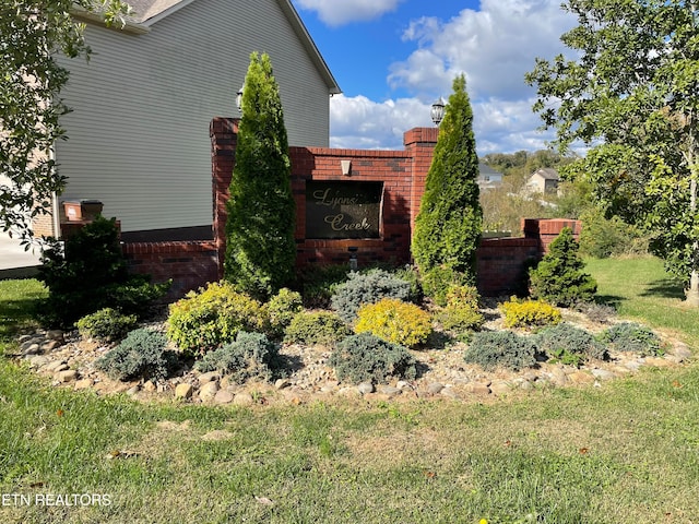 view of side of home with a yard