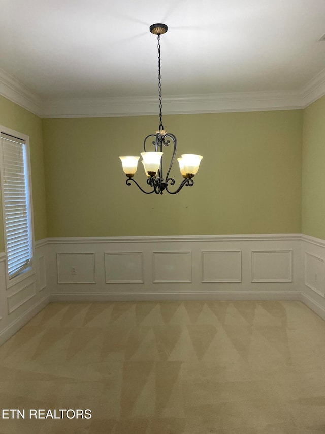 unfurnished room featuring a notable chandelier, crown molding, and light carpet