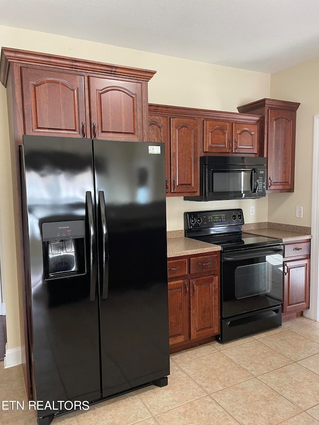 kitchen with black appliances and light tile patterned flooring