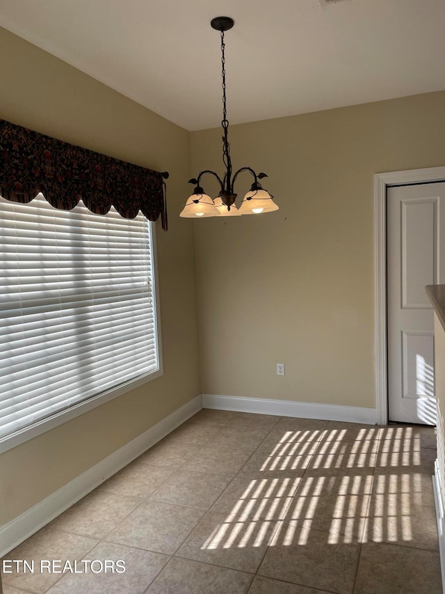 unfurnished dining area with light tile patterned flooring and a notable chandelier