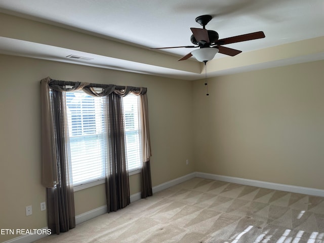 carpeted spare room with ceiling fan