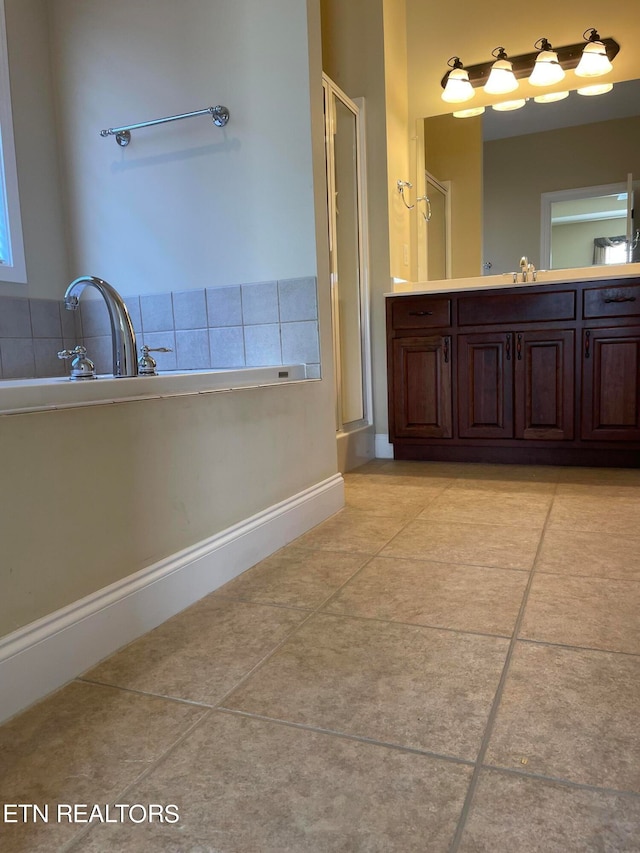 bathroom with vanity, tile patterned floors, and shower with separate bathtub