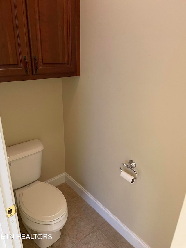 bathroom featuring toilet and tile patterned flooring