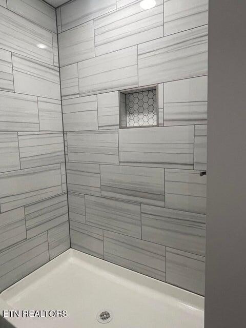 bathroom with tiled shower