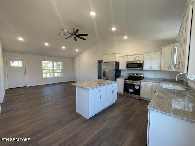 kitchen featuring stainless steel appliances, sink, a center island, white cabinetry, and dark hardwood / wood-style flooring