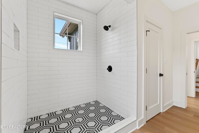 bathroom featuring tiled shower and hardwood / wood-style flooring