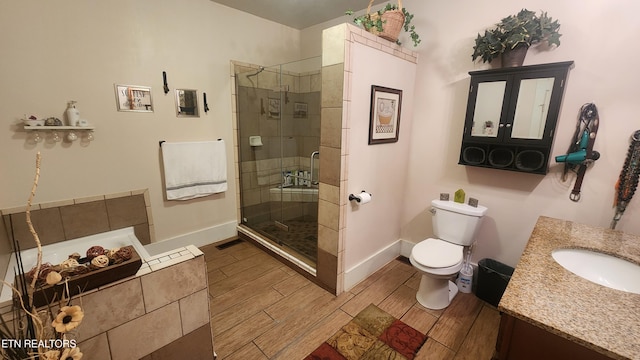 bathroom featuring toilet, an enclosed shower, and vanity