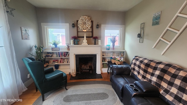 sitting room with hardwood / wood-style flooring and plenty of natural light