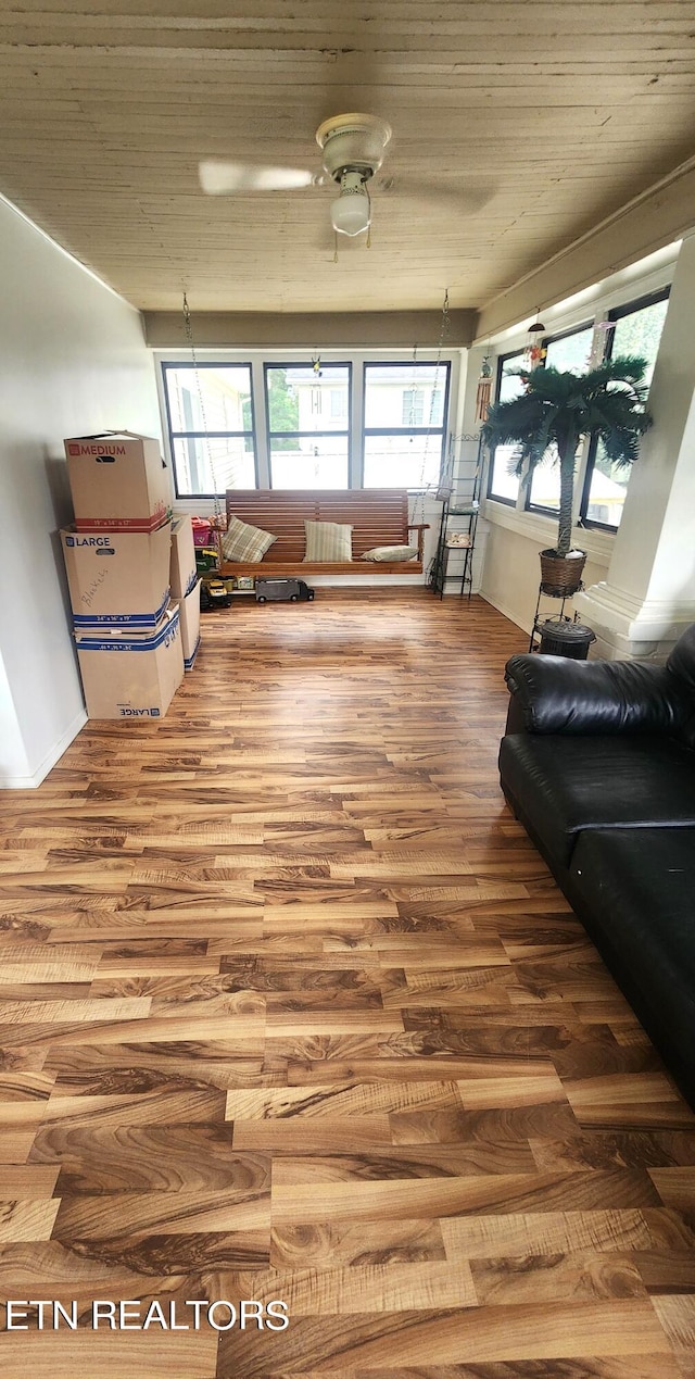 living room featuring wood-type flooring and ceiling fan