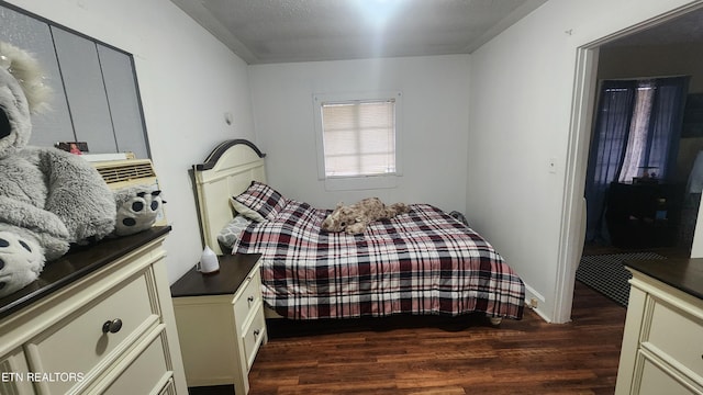 bedroom with dark hardwood / wood-style flooring