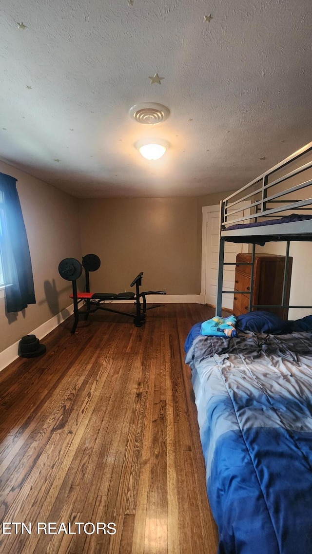 unfurnished bedroom featuring a textured ceiling and wood-type flooring