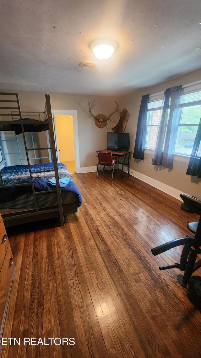 unfurnished bedroom with hardwood / wood-style flooring