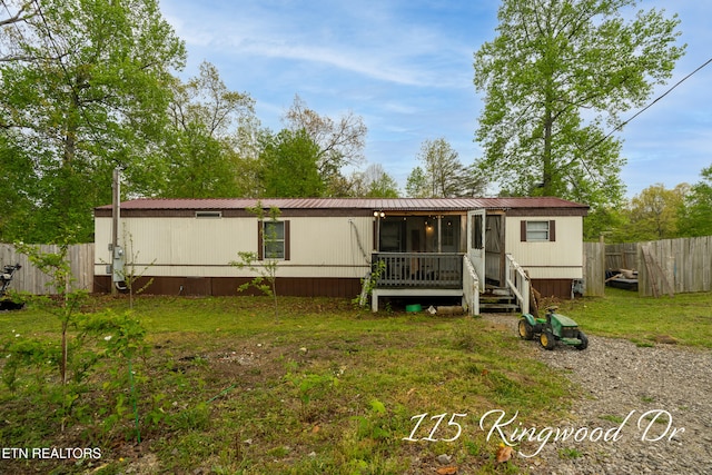 back of property with a lawn