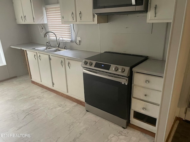 kitchen featuring white cabinetry, stainless steel appliances, and sink