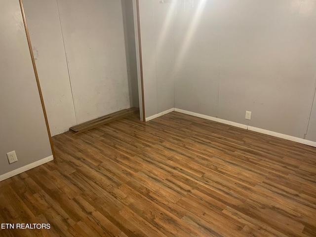 unfurnished bedroom with dark hardwood / wood-style floors