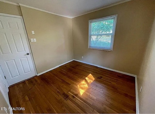 unfurnished room featuring crown molding and dark wood-type flooring