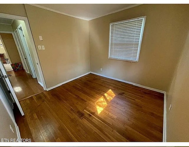 spare room with dark hardwood / wood-style flooring