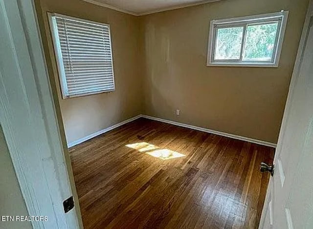 spare room with dark hardwood / wood-style flooring