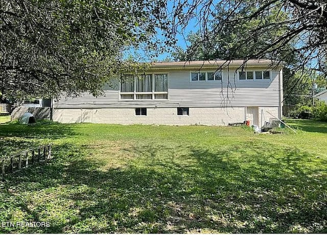 back of house with a lawn