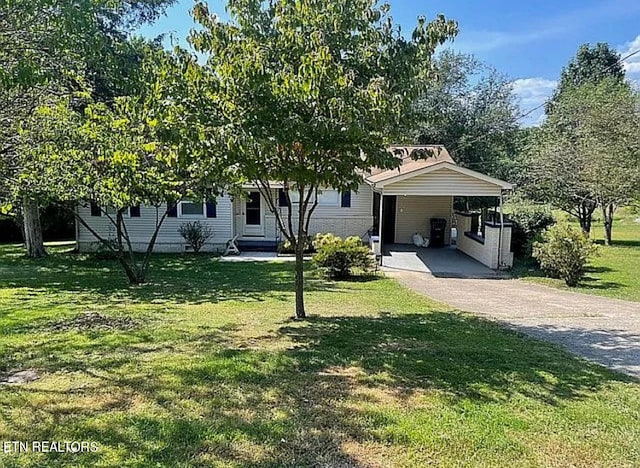 view of front of property with a carport and a front yard