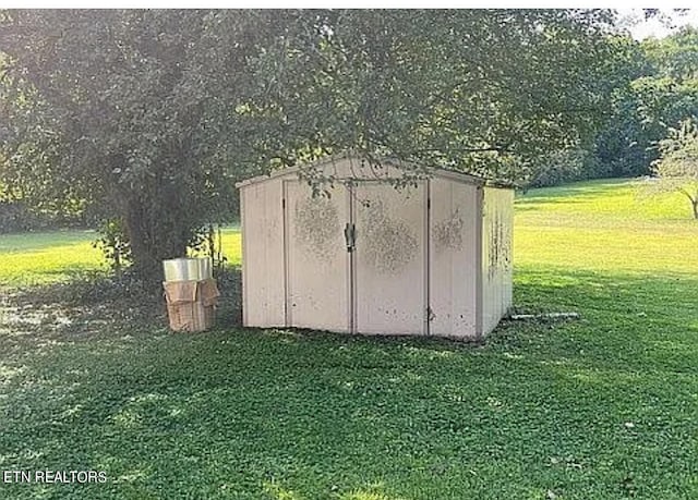 view of outbuilding with a lawn