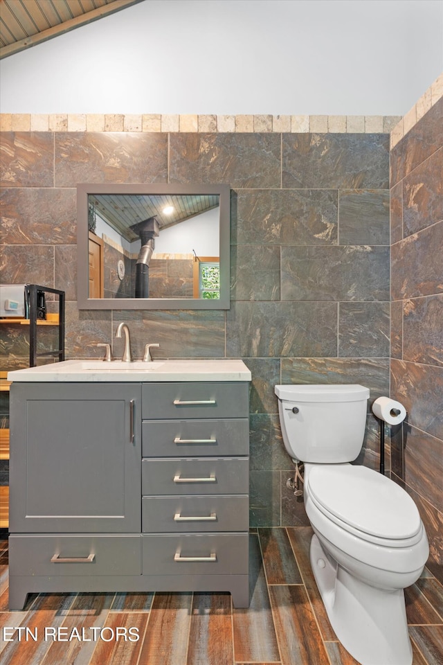 bathroom with tile walls and vanity