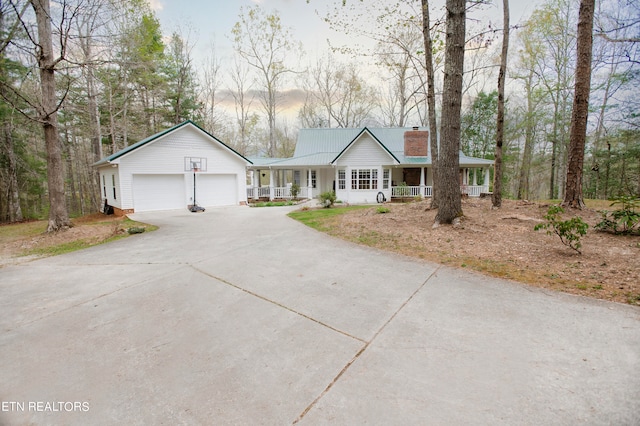 ranch-style home featuring a porch and a garage