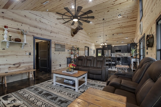 living room featuring high vaulted ceiling, wooden walls, wood ceiling, and ceiling fan with notable chandelier