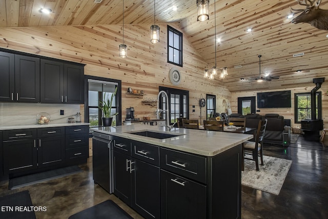 kitchen with high vaulted ceiling, pendant lighting, wood ceiling, and a kitchen island with sink