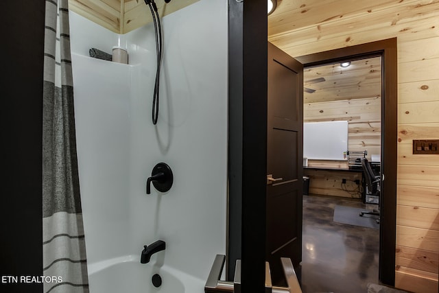 bathroom featuring wood walls, shower / bath combination with curtain, and wooden ceiling