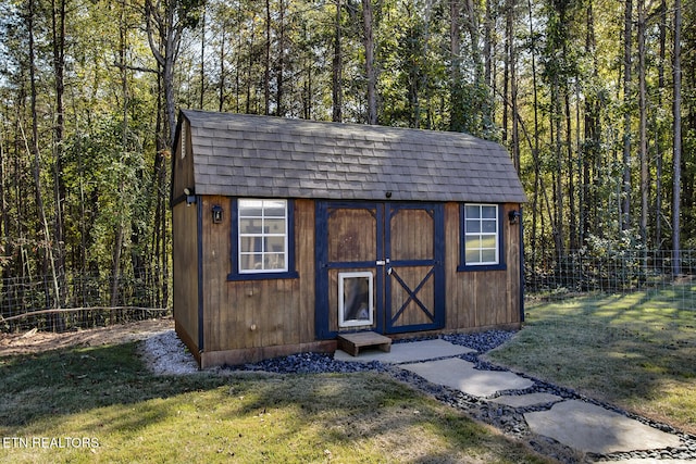 view of outdoor structure featuring a lawn