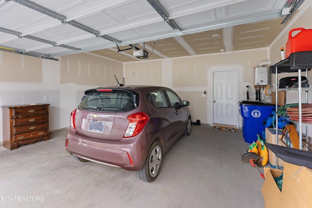 garage with a garage door opener and tankless water heater