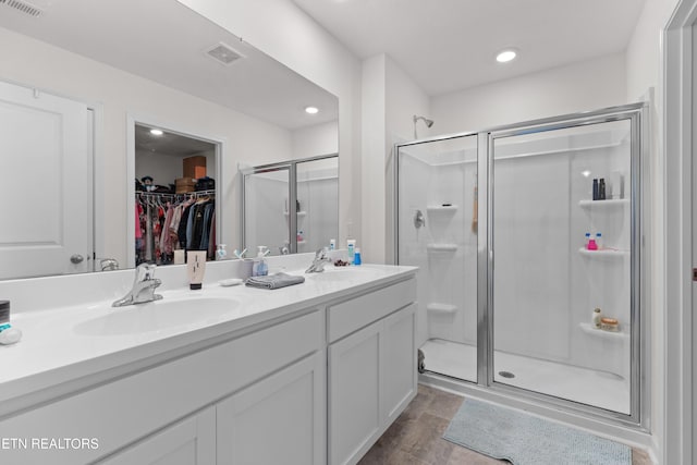 bathroom featuring vanity and an enclosed shower