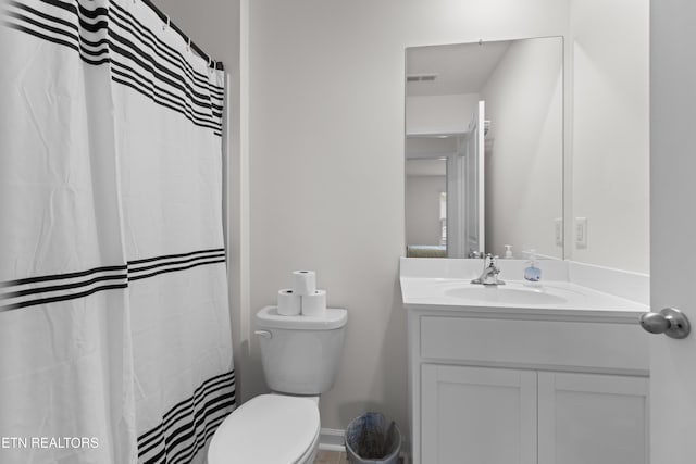 bathroom with vanity, a shower with curtain, and toilet