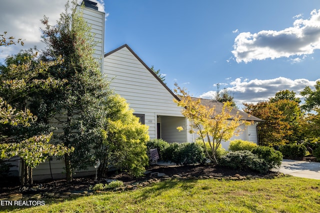 view of side of home featuring a garage