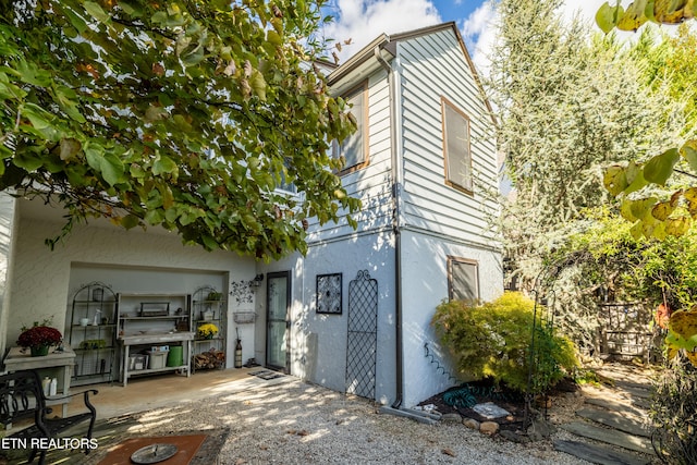 view of side of property featuring a patio area