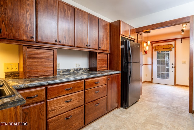 kitchen with black refrigerator and decorative light fixtures