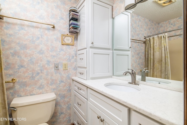 bathroom featuring vanity, curtained shower, a textured ceiling, and toilet