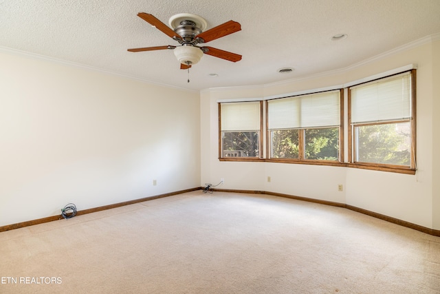 empty room with light carpet, crown molding, a textured ceiling, and ceiling fan