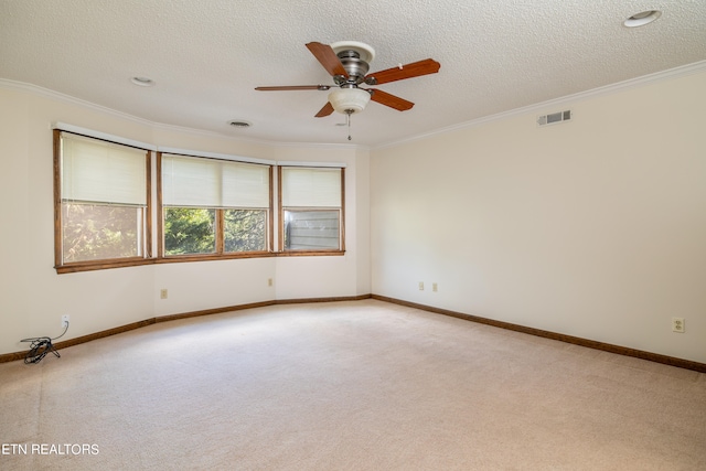 unfurnished room with crown molding, a textured ceiling, light colored carpet, and ceiling fan