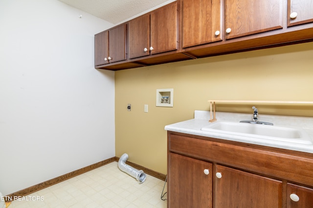 clothes washing area with electric dryer hookup, washer hookup, sink, cabinets, and a textured ceiling